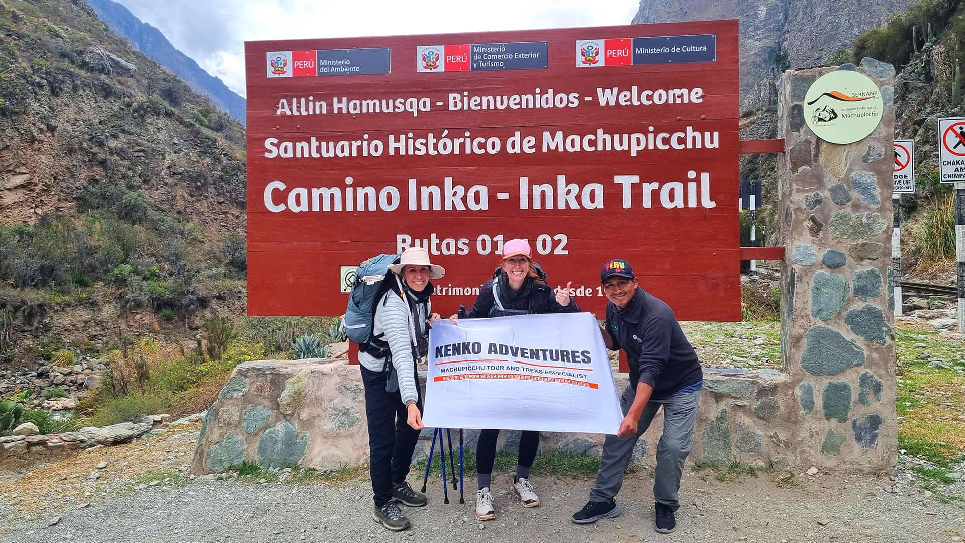 Two Tourists in the Sacred Valley Holding a Kenko Adventures Flag Two Tourists in the Sacred Valley Holding a Kenko Adventures Flag